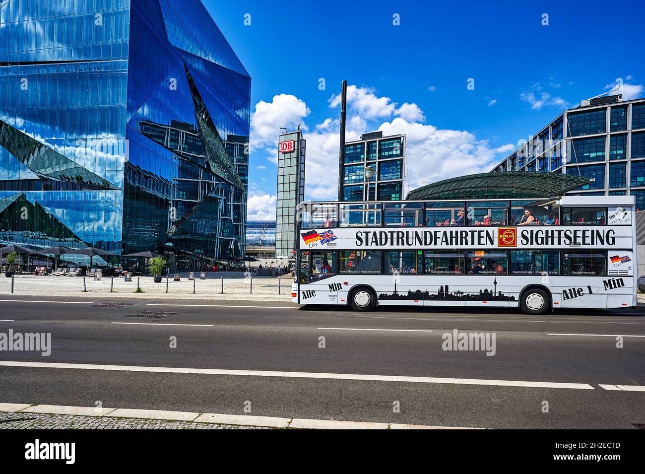 Berlin, Germany - July 29, 2021: Hop on hop off bus near the Hauptbahnhof in downtown Berlin. At the left side you can see the Cube Berlin. Stock Photo