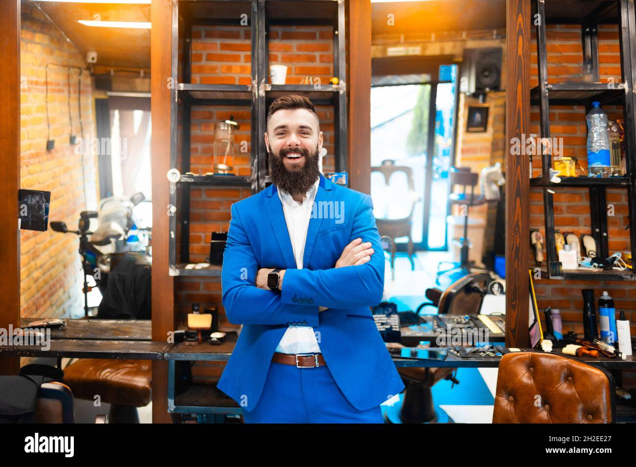Hair salon owner posing inside his business Stock Photo