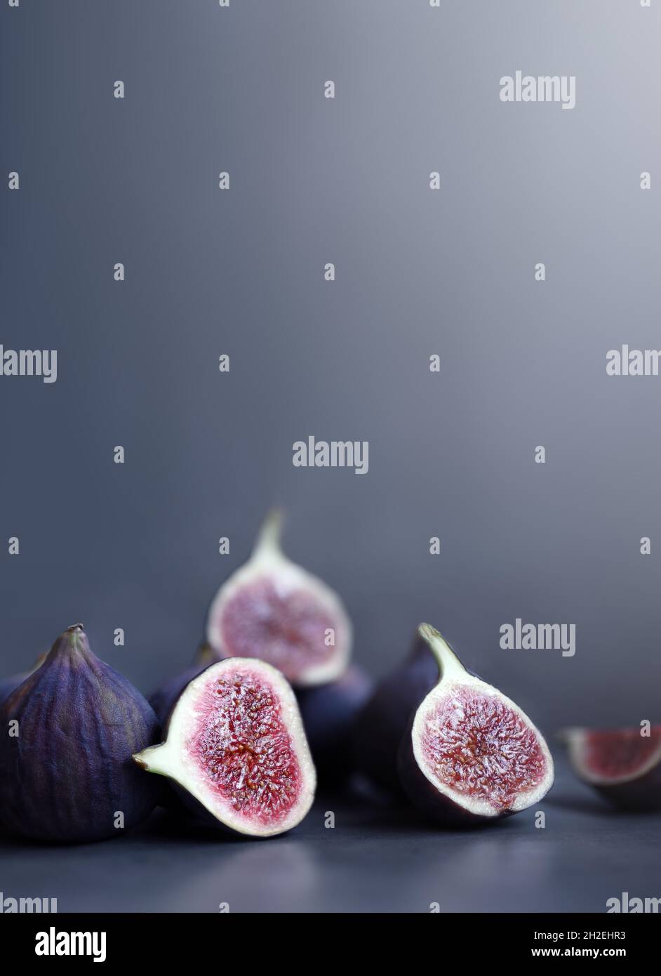 Fresh figs on violet background. Beautiful blue violet figs. Stock Photo