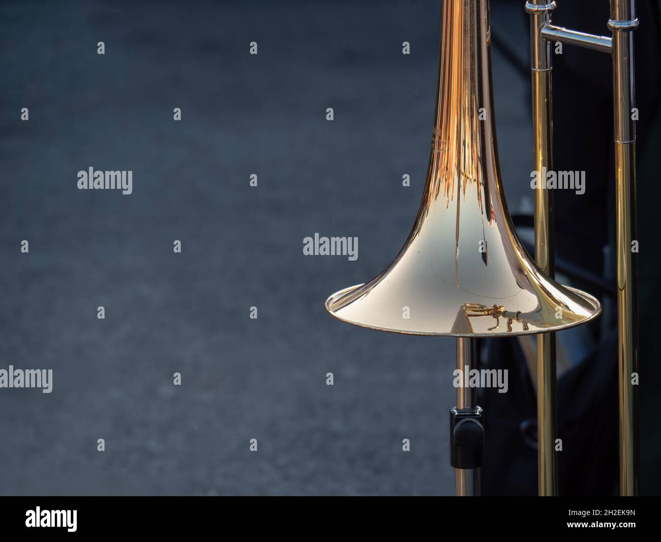 Trombone at rest over background for musical copy, copyspace. Stock Photo