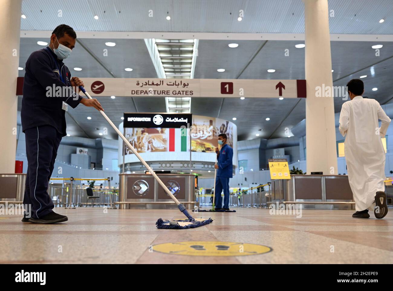 Farwaniya, Kuwait. 21st Oct, 2021. A worker mops the floor in the