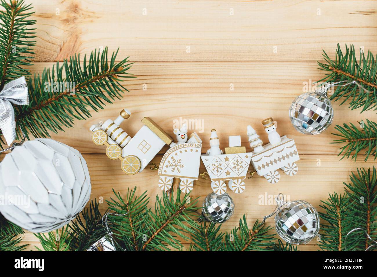Christmas decoration with branches and a white little train , toys on natural background. Stock Photo