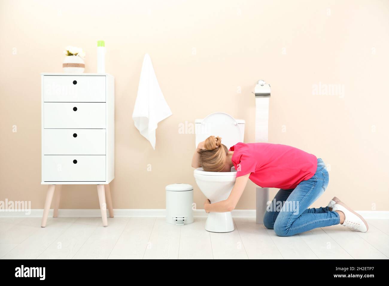 Young woman vomiting in toilet bowl at home Stock Photo Alamy