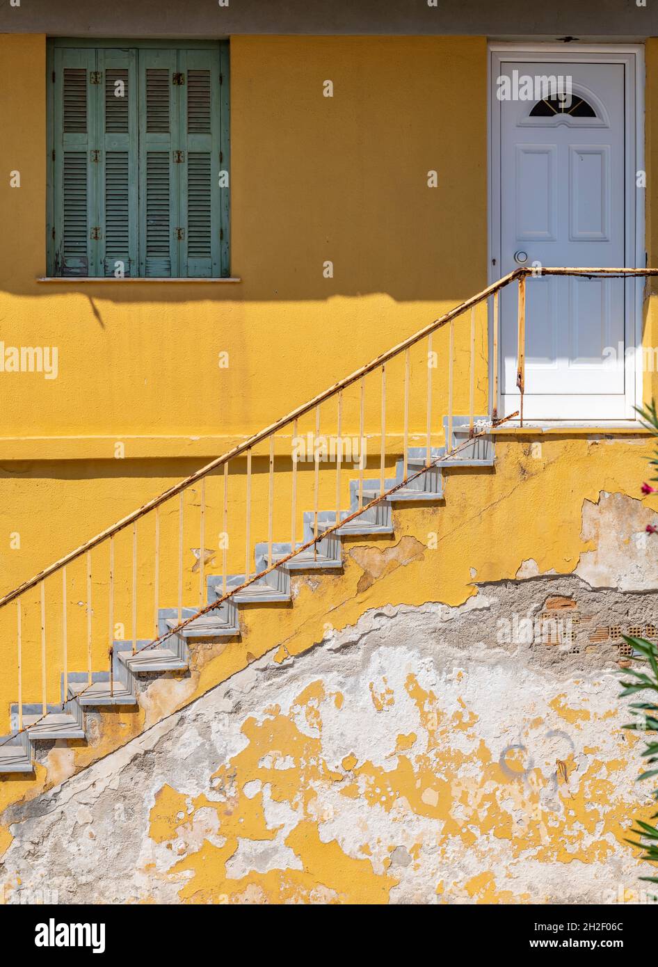 yellow painted wall and flight of steps with white front door on a greek building. bright yellow stairs and steps, flight of steps, staircase, yellow, Stock Photo
