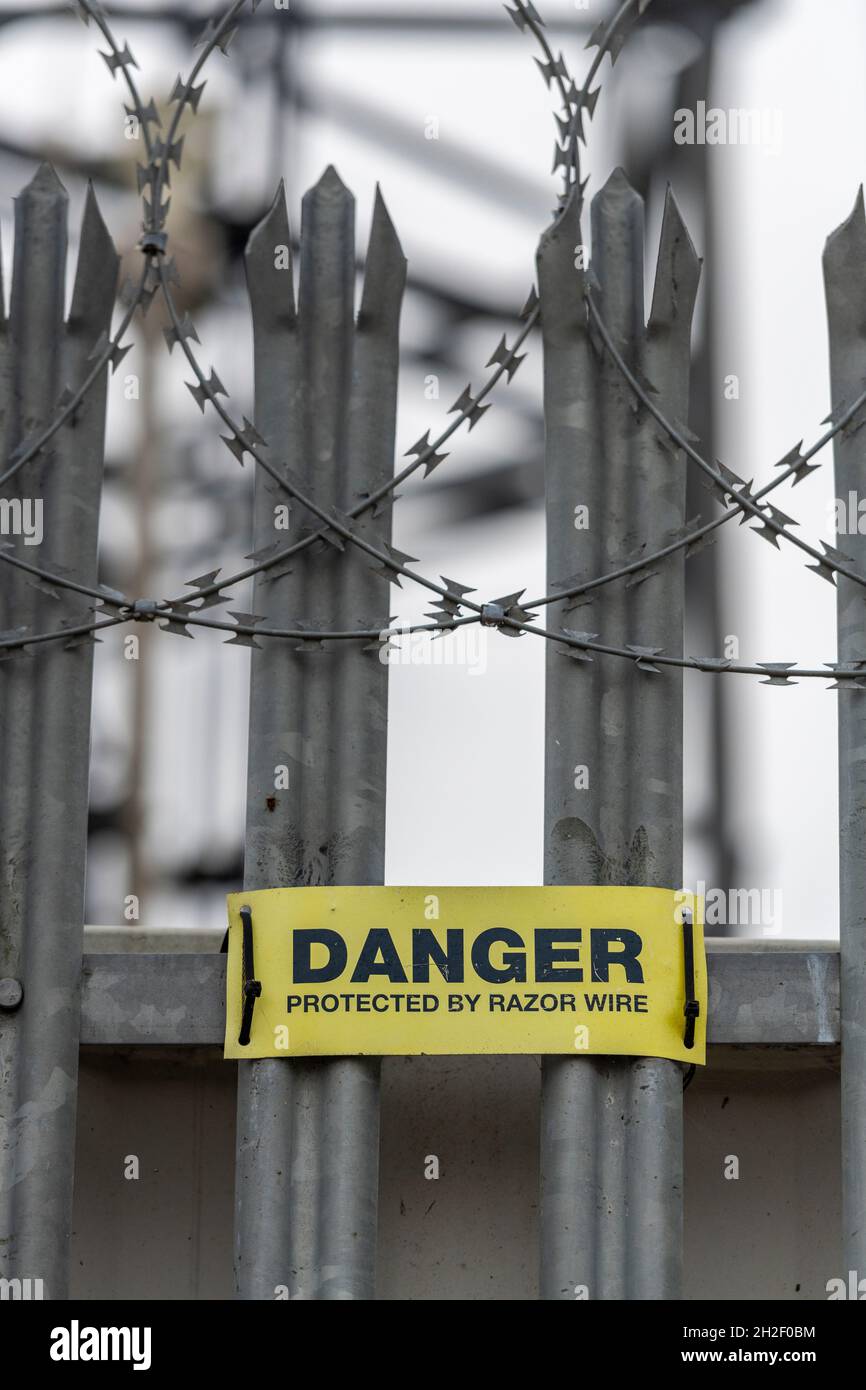 razor wire sign warning of danger from injury, razor wire, security