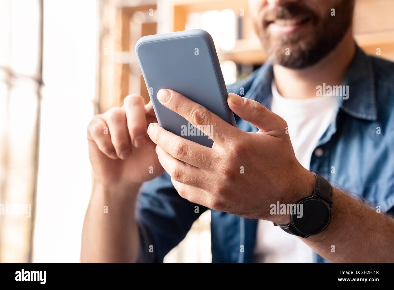 Closeup man using smartphone for social media networking, making video call Stock Photo