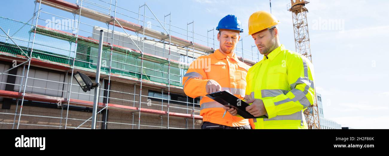 Construct Site Engineer Pointing. Worker Inspector With Clipboard Stock Photo