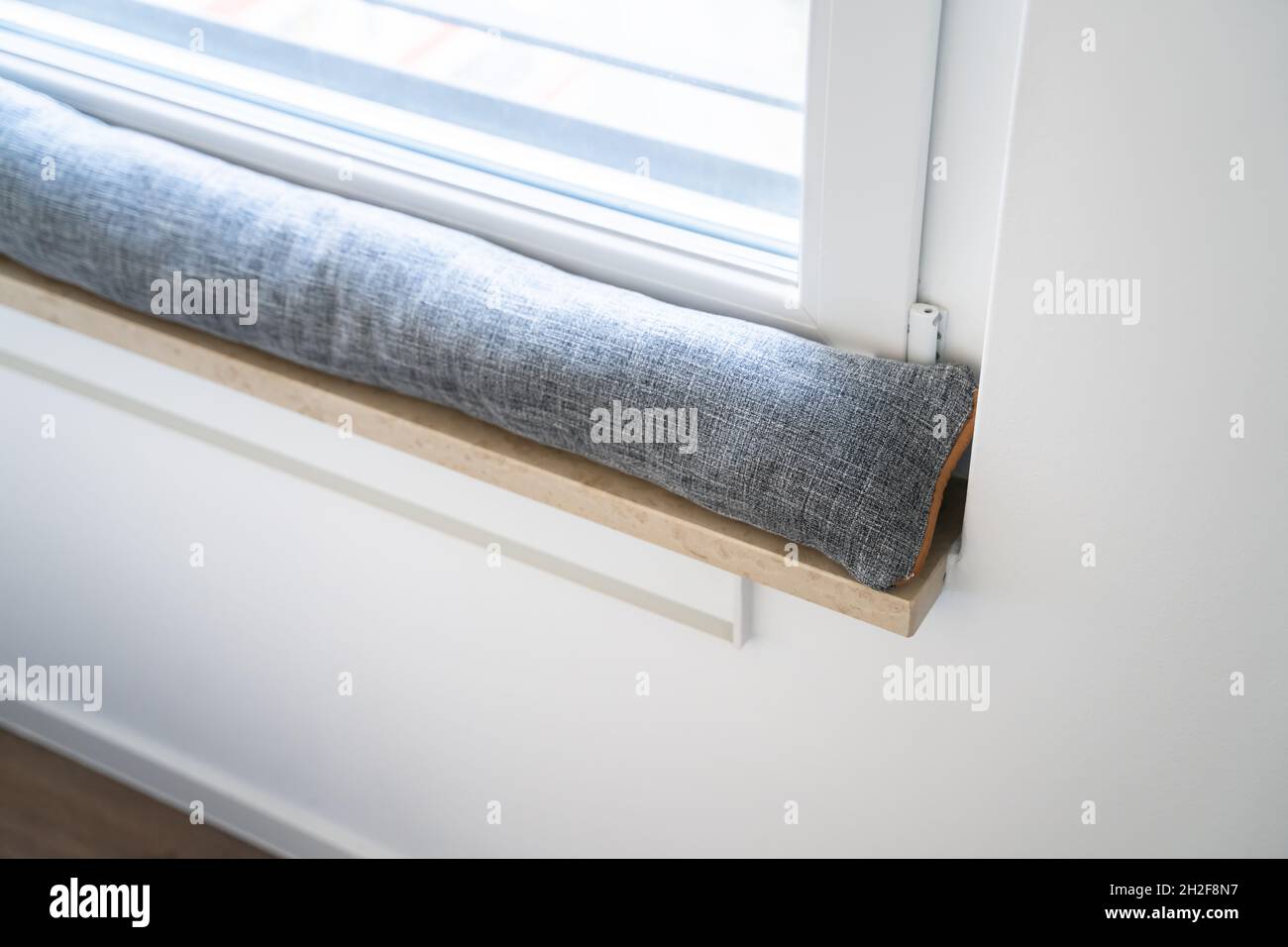 Draft Excluder Under Window Blocking Cold Air From Traveling Around