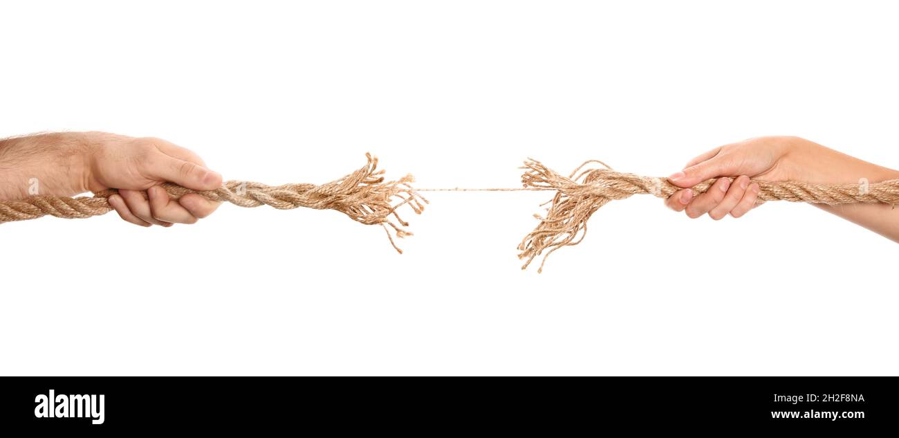 Man and woman pulling frayed rope at breaking point on white background ...