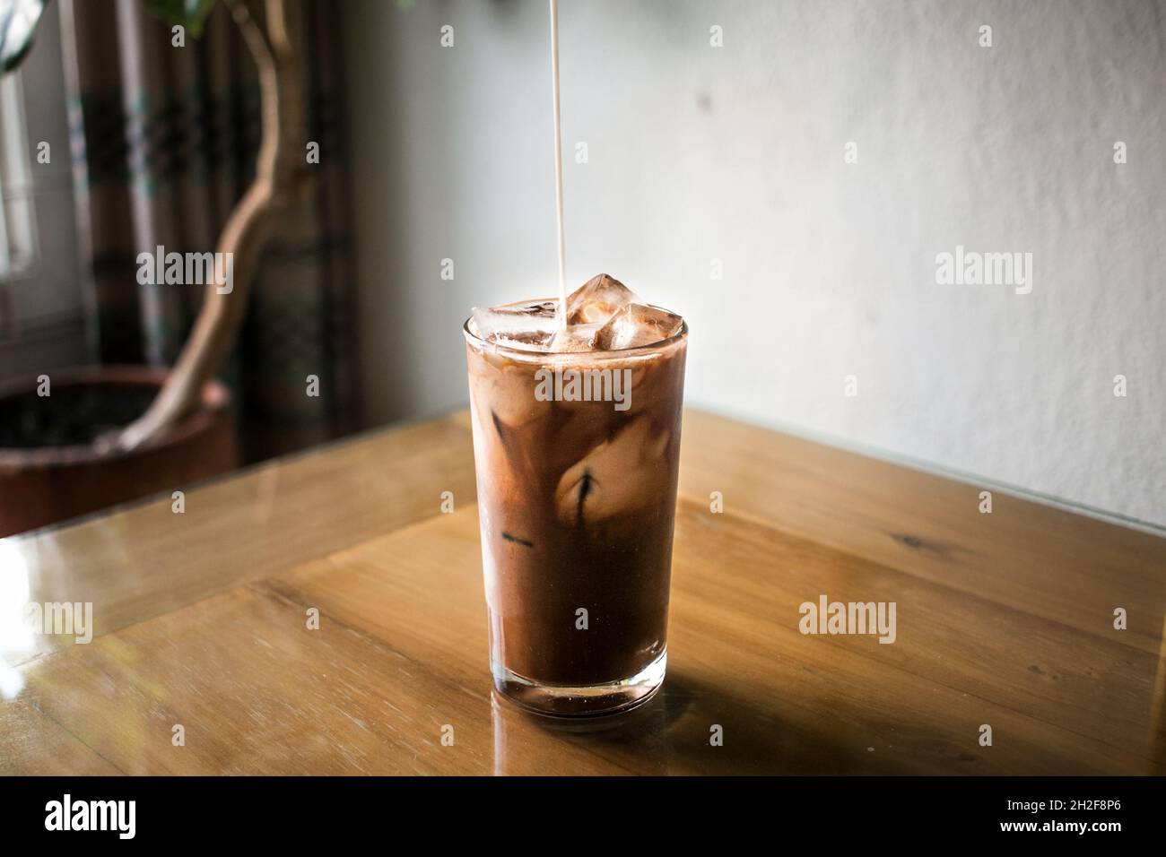 Delicious Iced coffee on brown wooden table Stock Photo