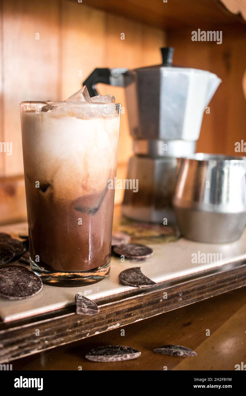 Ready to drink delicious chocolate iced coffee on tray with chocolate, sleek wooden vibes Stock Photo