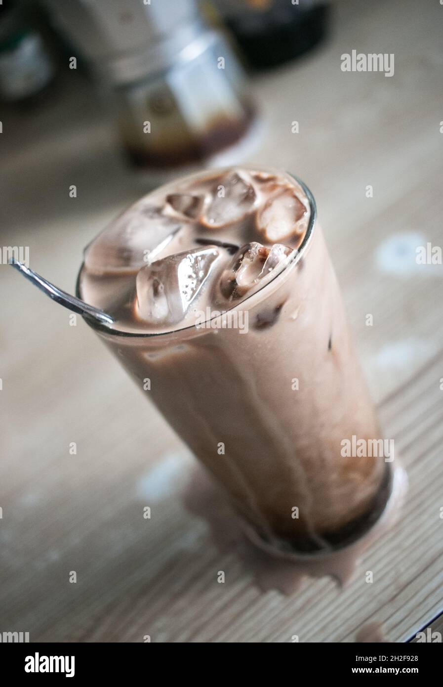 Overflowing, stirred Iced Coffee on Kitchen counter Stock Photo