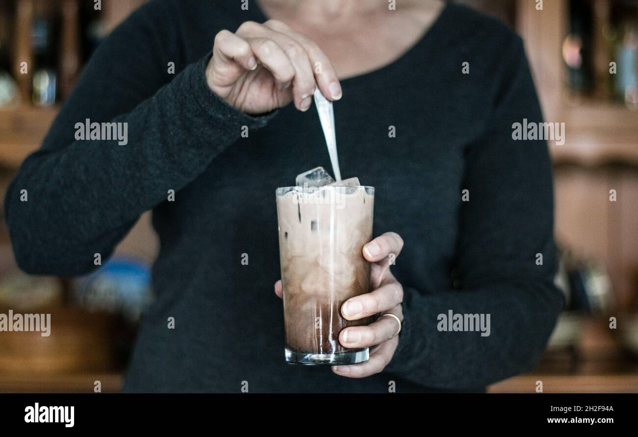 Mom making iced coffee to drink for breakfast Stock Photo