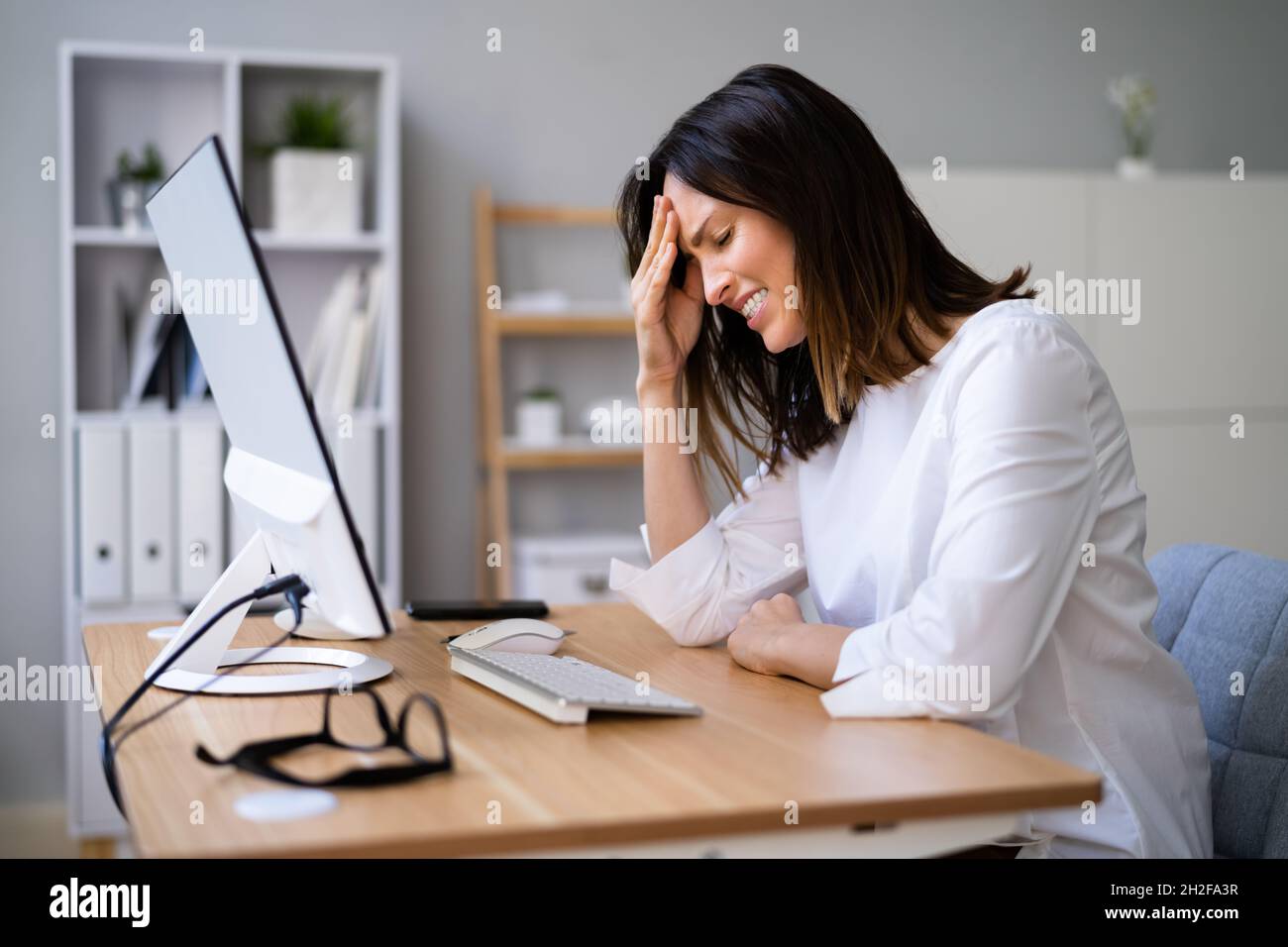 Stressful Business Woman Working On Computer In Office Stock Photo