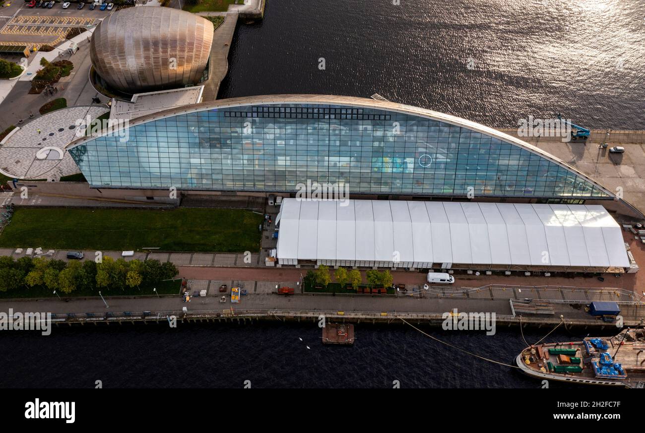 Glasgow, Scotland, UK. 21st Oct, 2021. PICTURED: Drone arial view of the COP26 site showing temporary structures still being constructed. 10 days until the start of COP26. The COP26 site showing temporary structures half built on the grounds of the Scottish Event Campus (SEC) Previously known as Scottish Exhibition and Conference Centre (SECC). Security fences with a ‘ring of steel' encapsulates the COP26 conference site. CCTV stations with emergency lights and loudspeakers are positioned all over the site. Credit: Colin Fisher/Alamy Live News Stock Photo