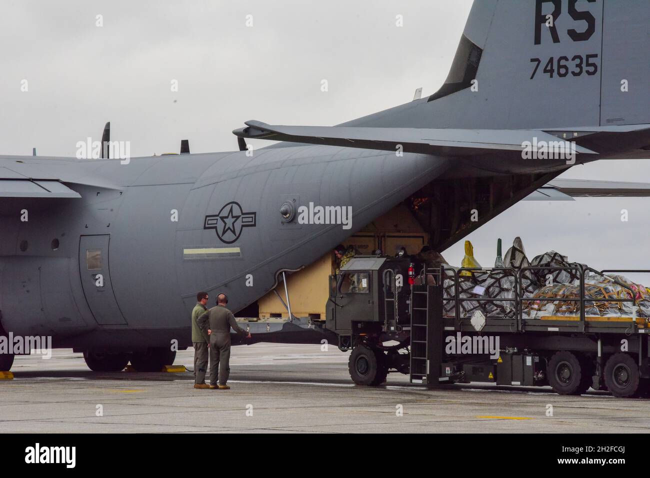 U.S. Airmen load cargo onto a C130J Super Hercules aircraft assigned