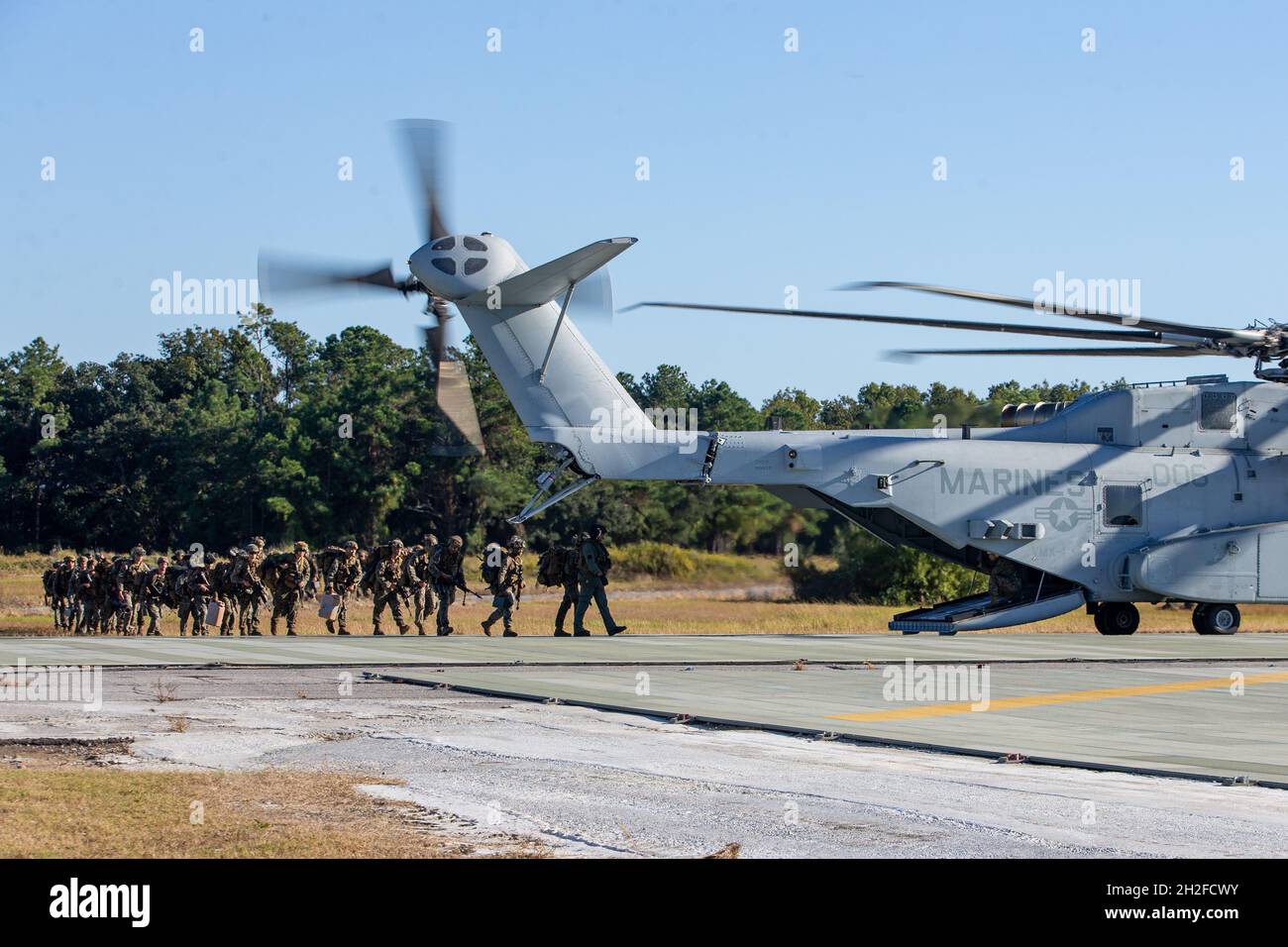 U.S. Marines with 1st Battalion, 2nd Marine Regiment, board a CH-53K King Stallion assigned to Marine Operational Test and Evaluation Squadron (VMX) 1 at Marine Corps Auxiliary Landing Field Bogue, North Carolina, Oct. 20, 2021. The CH-53K King Stallion will replace the CH-53E Super Stallion, which has served the Marine Corps for 40 years, and will transport Marines, heavy equipment, and supplies during ship-to-shore movement in support of amphibious assault and subsequent operations ashore. (U.S. Marine Corps photo by Lance Cpl. Elias E. Pimentel III) Stock Photo