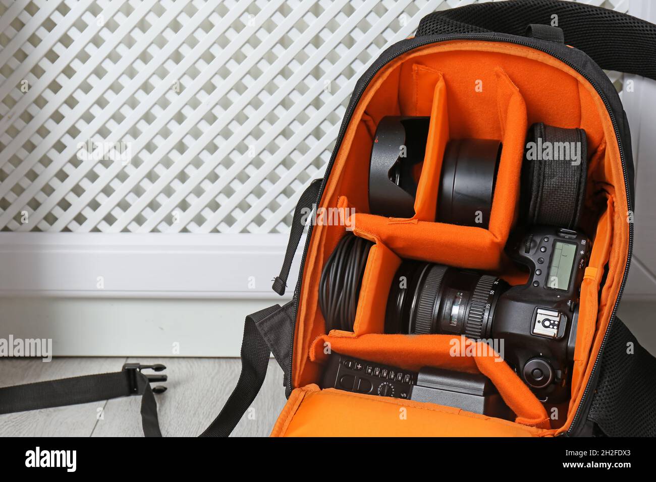 Bag with digital camera on floor indoors. Professional photographer's  equipment Stock Photo - Alamy