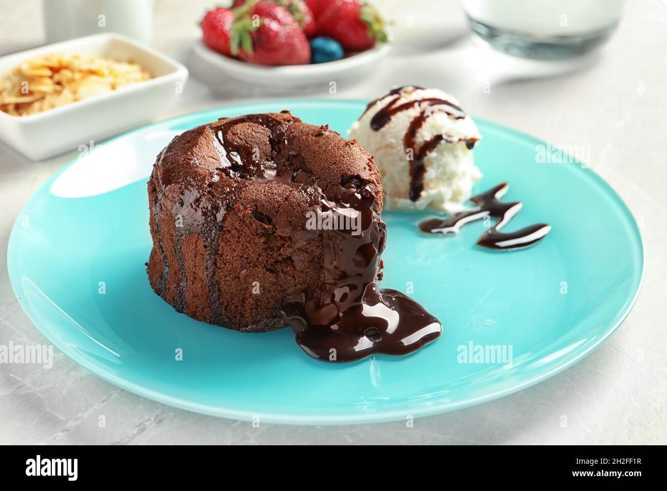 Plate of delicious fresh fondant with hot chocolate and ice cream on
