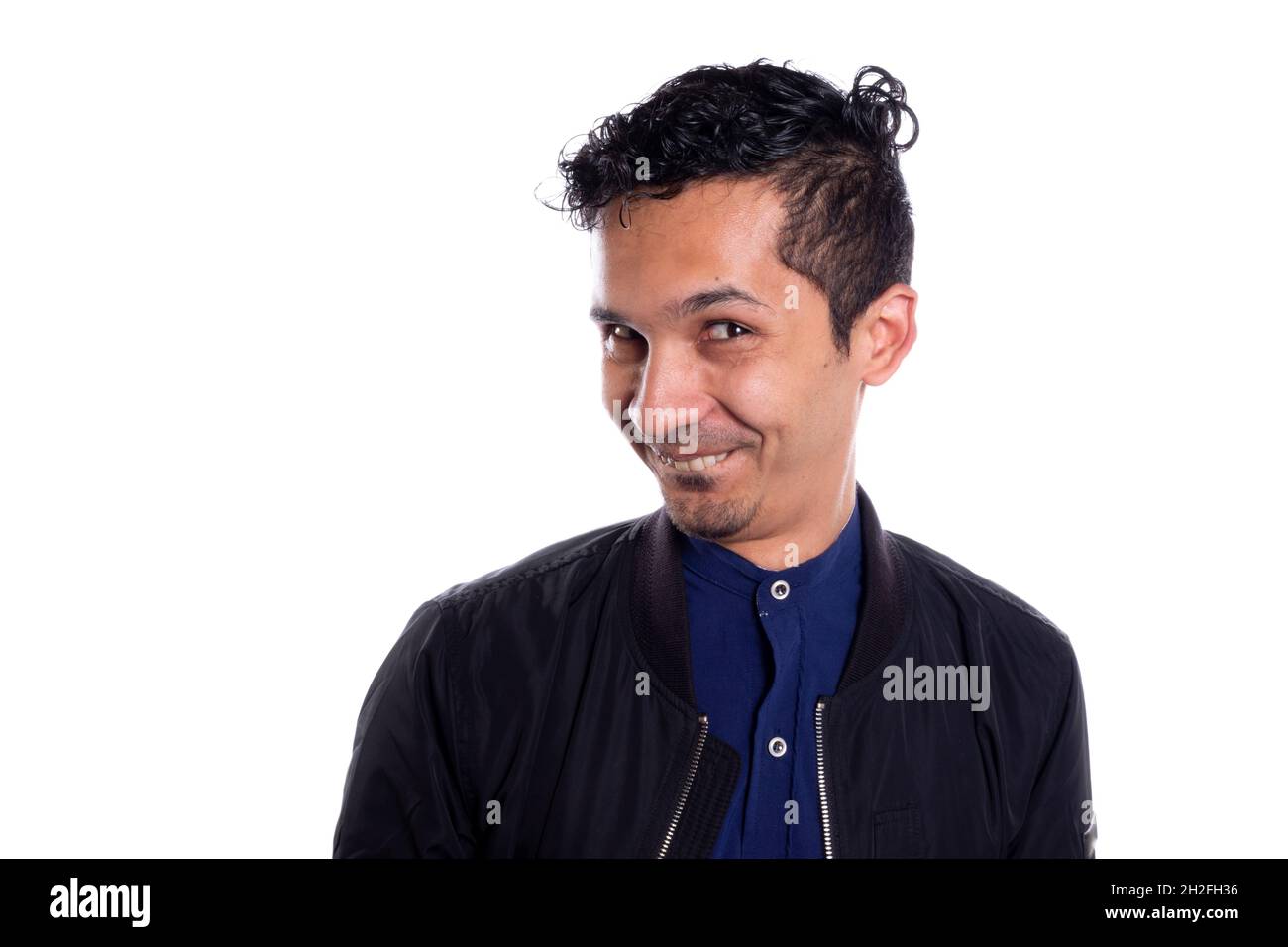 Smile of a Latin man flirting. Isolated on white background. Smirking and Whimsical Face. Funny face. Gestures and expressions. Funny and awkward Stock Photo