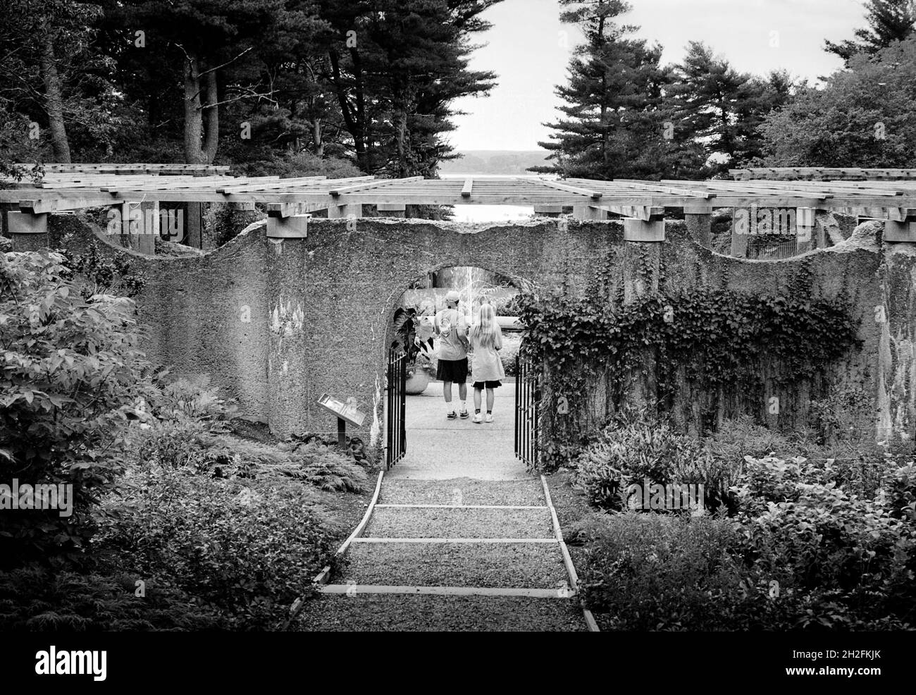 Entry to the old Rose Garden and fountain with two visitors holding