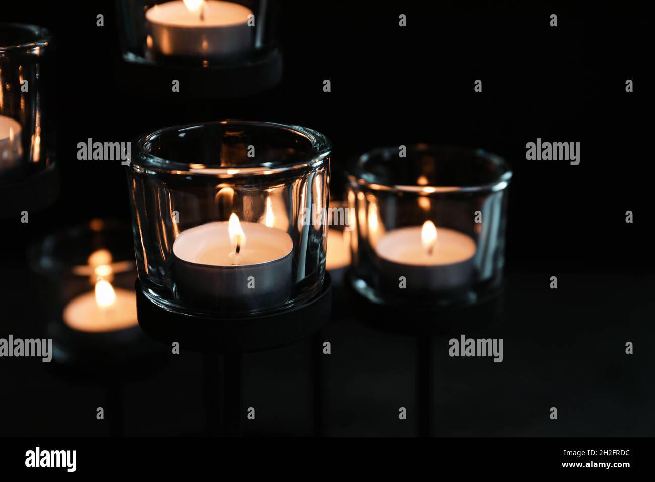 Burning candles on dark background. Funeral symbol Stock Photo Alamy