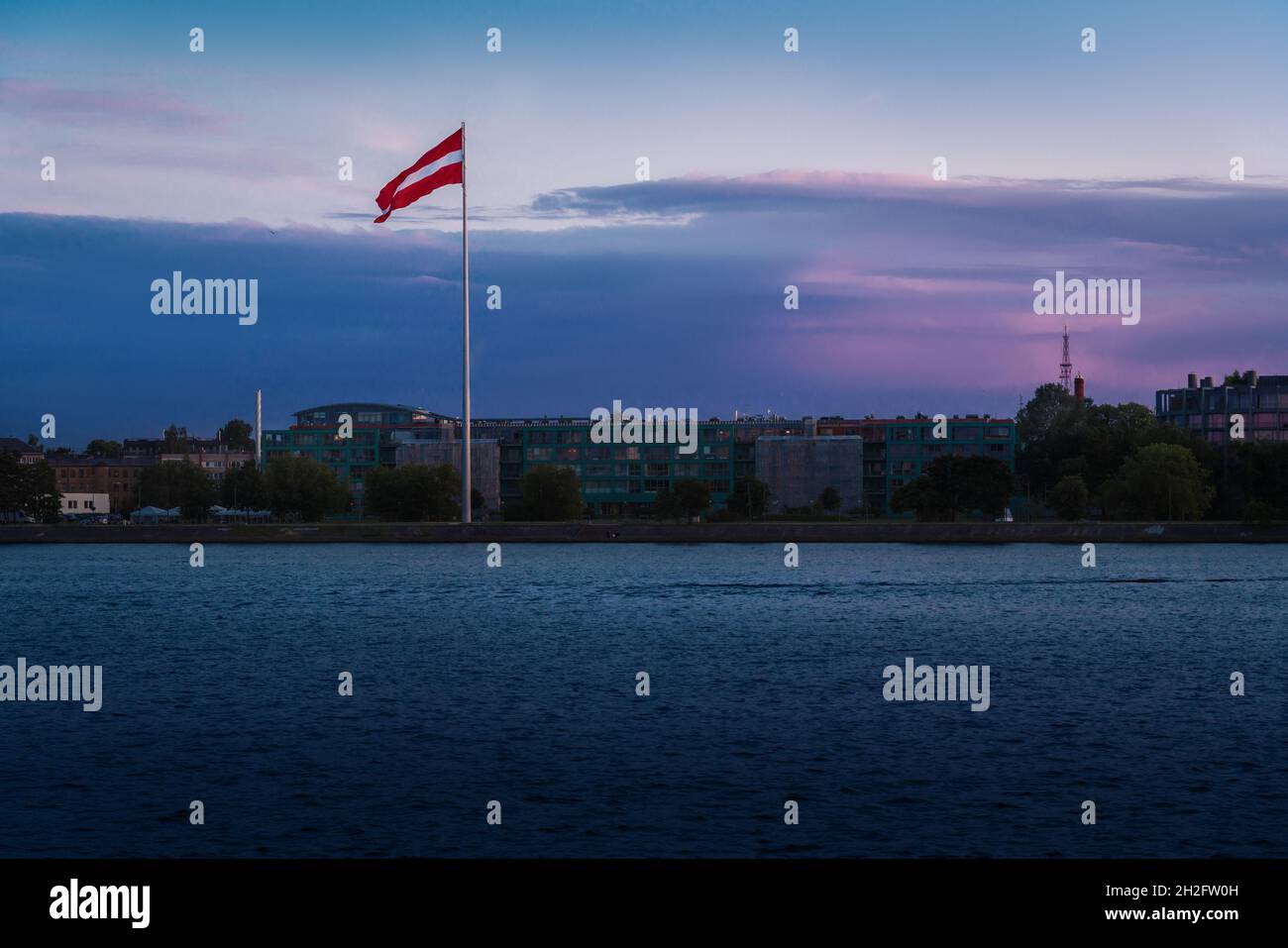 Sunset view of Latvian Flag on the West Bank of Daugava (Pardaugava) - Riga, Latvia Stock Photo