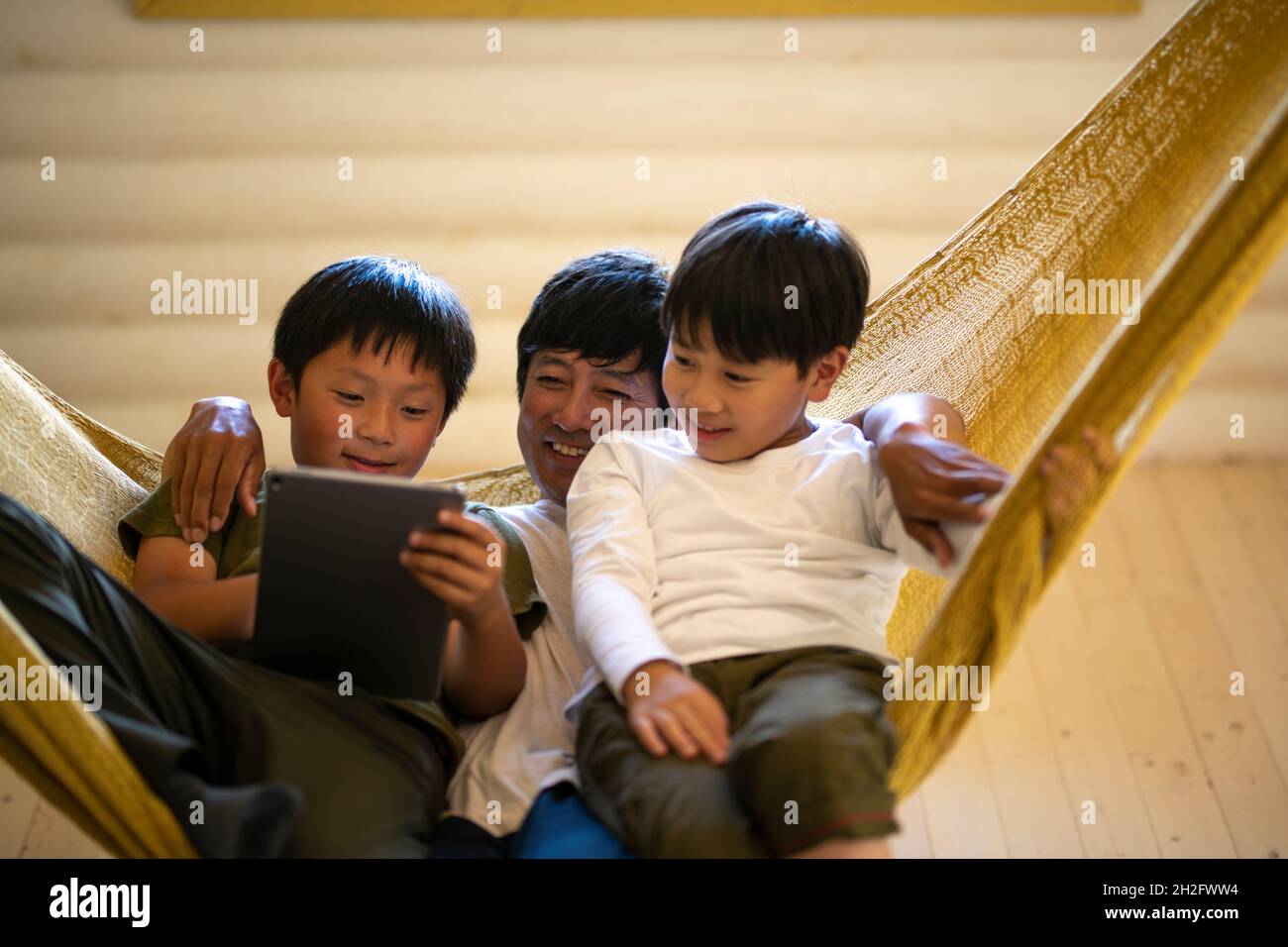 Father and Sons Relaxing in Hammock Stock Photo