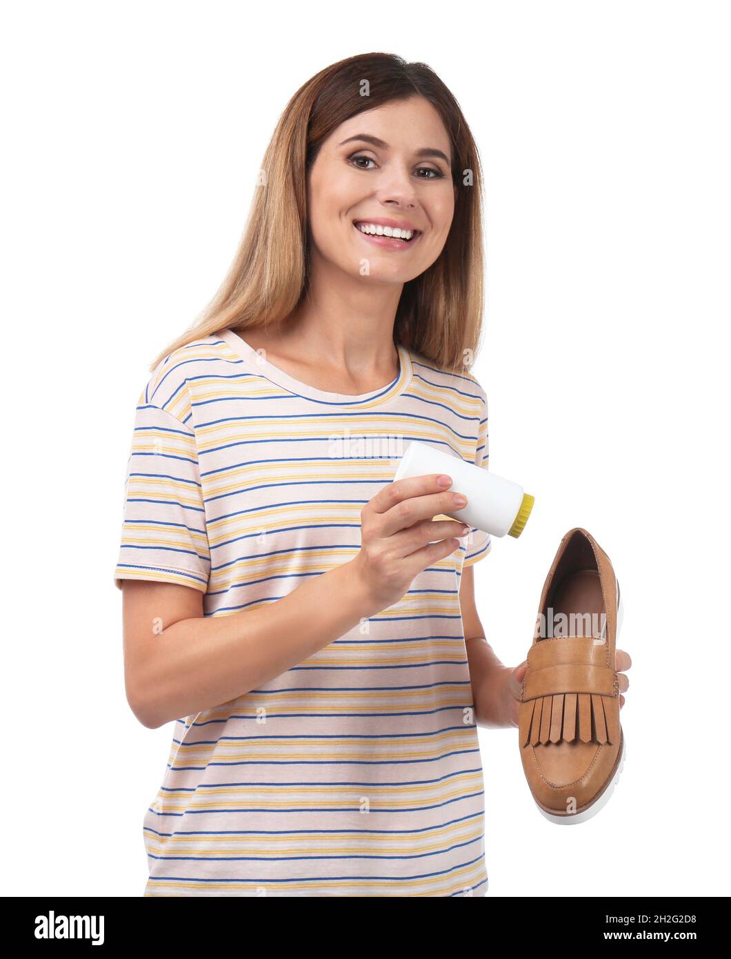 Woman putting powder freshener into shoe on white background Stock