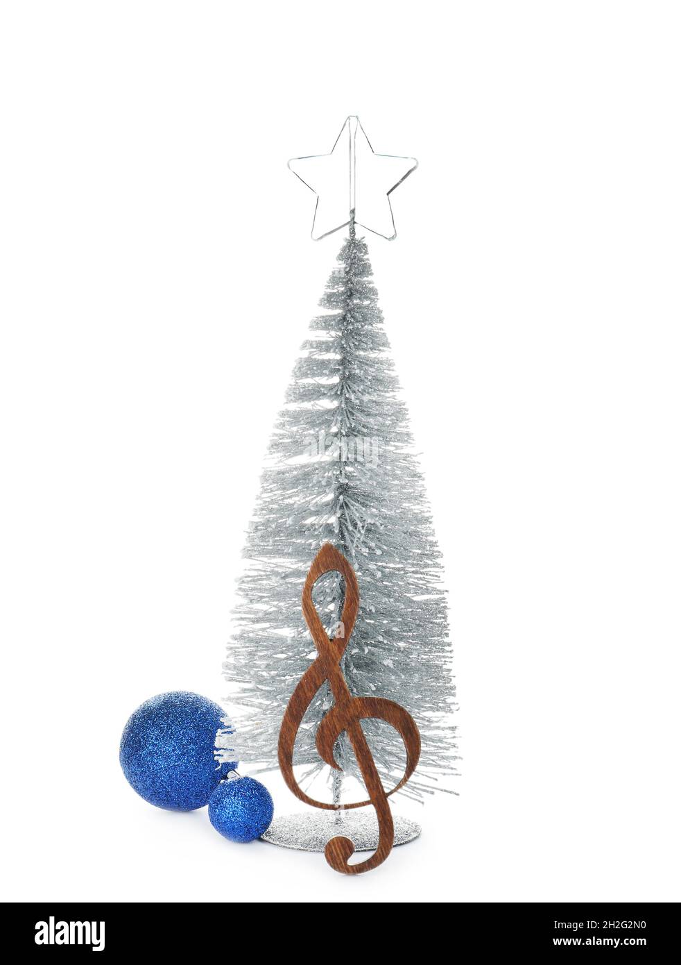 Composition with small Christmas tree, decor and wooden music note on