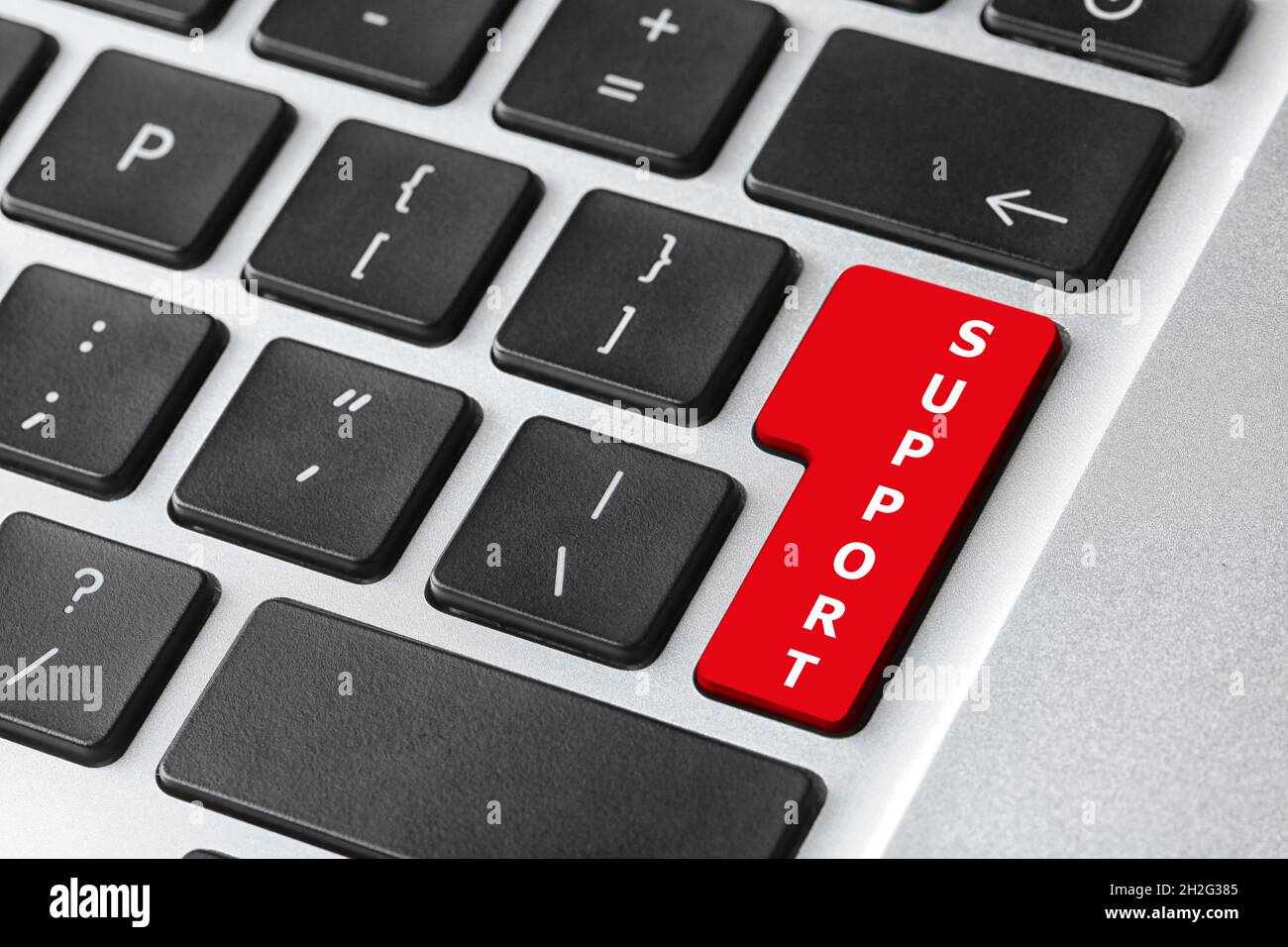 Closeup view of computer keyboard with red button. Technical support ...