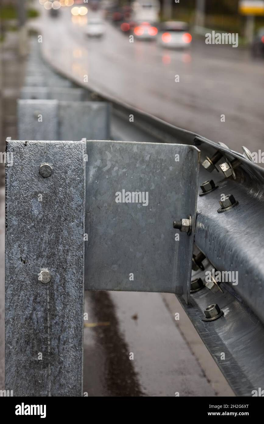 underscrewed nuts and bolts in highway road railing Stock Photo