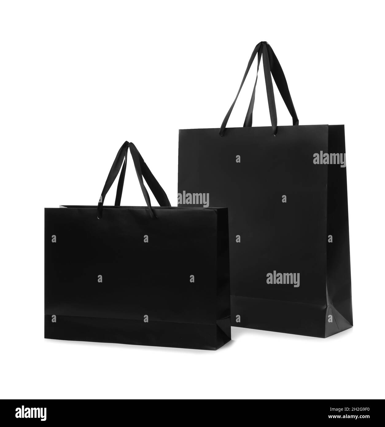 Paper shopping bags with handles on white background. Mockup for design