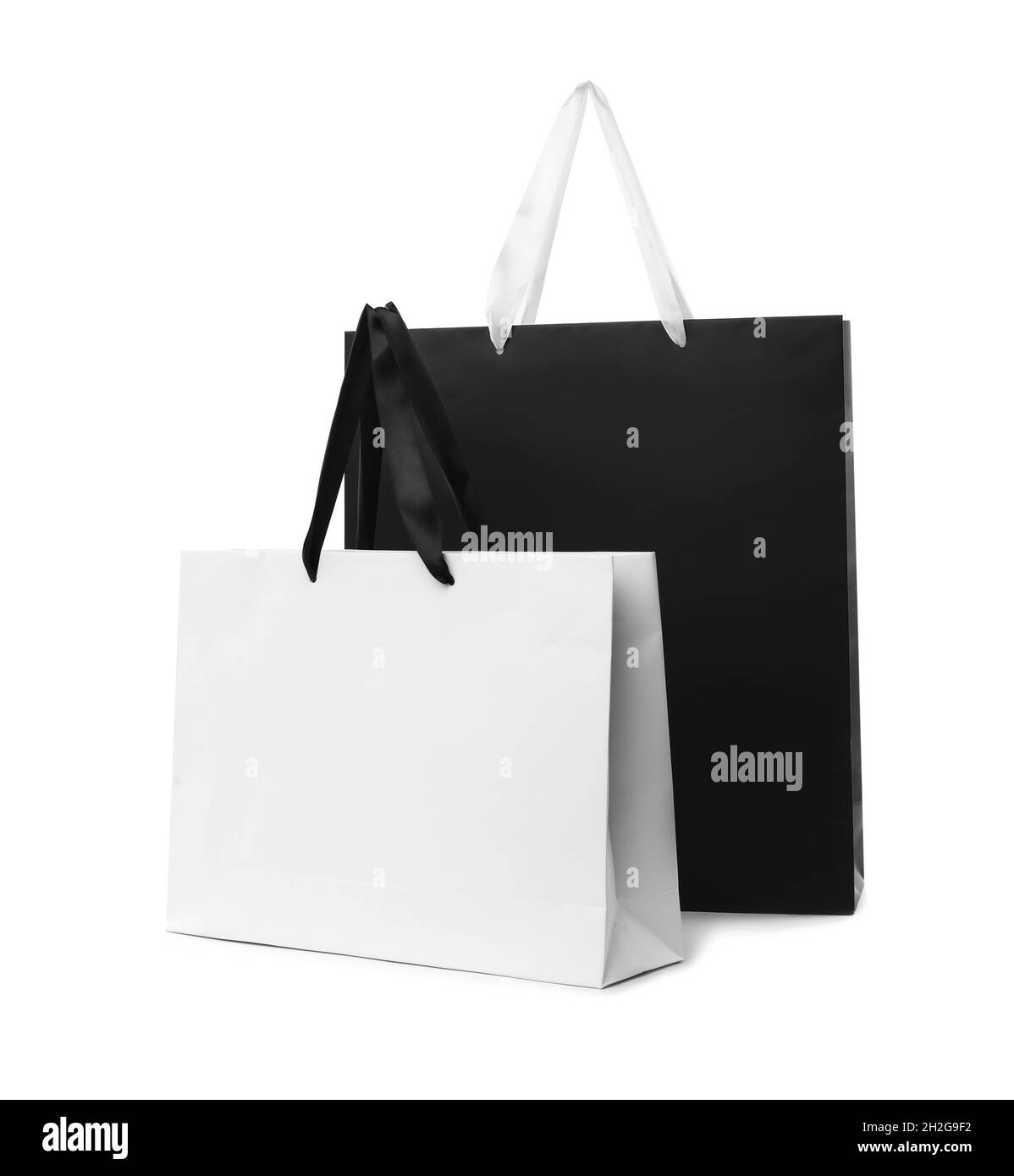 Paper shopping bags with handles on white background. Mockup for design