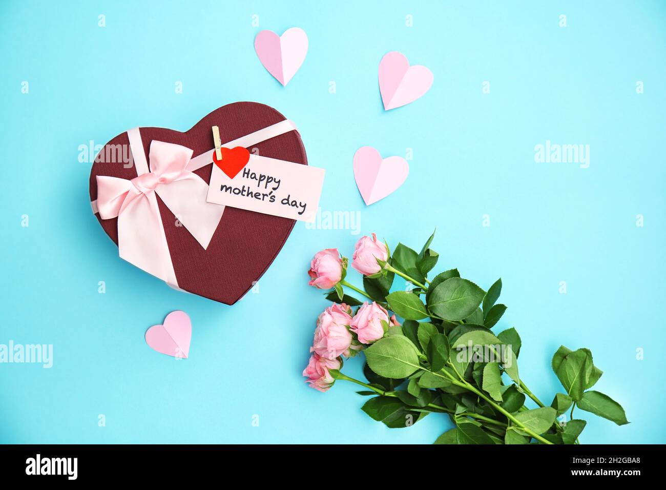 Gift box, roses and greeting card with text "HAPPY MOTHER'S DAY" on ...