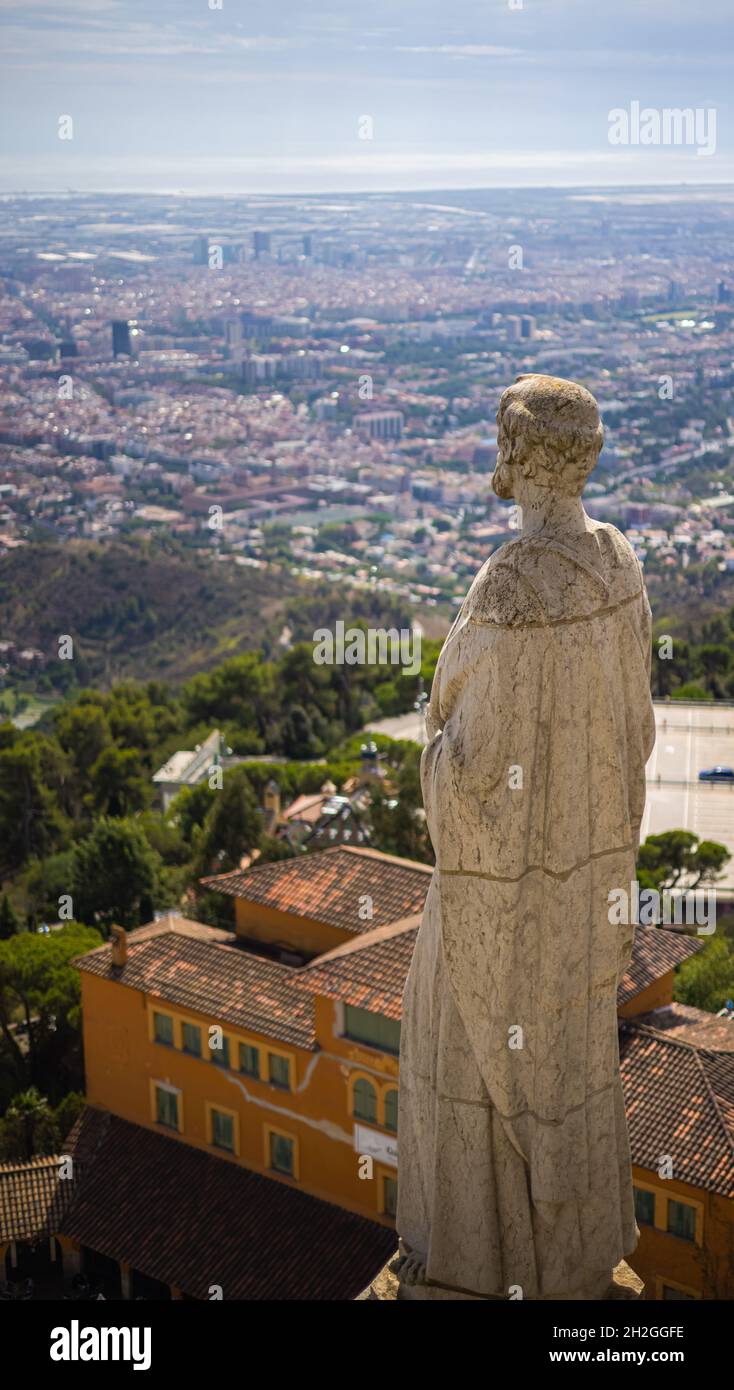 Stone statue on the roof of the Church of the Sacred Heart of Jesus on the summit of Parc Tibidabo in Barcelona, Spain. Cathedral sculptures, aerial Stock Photo