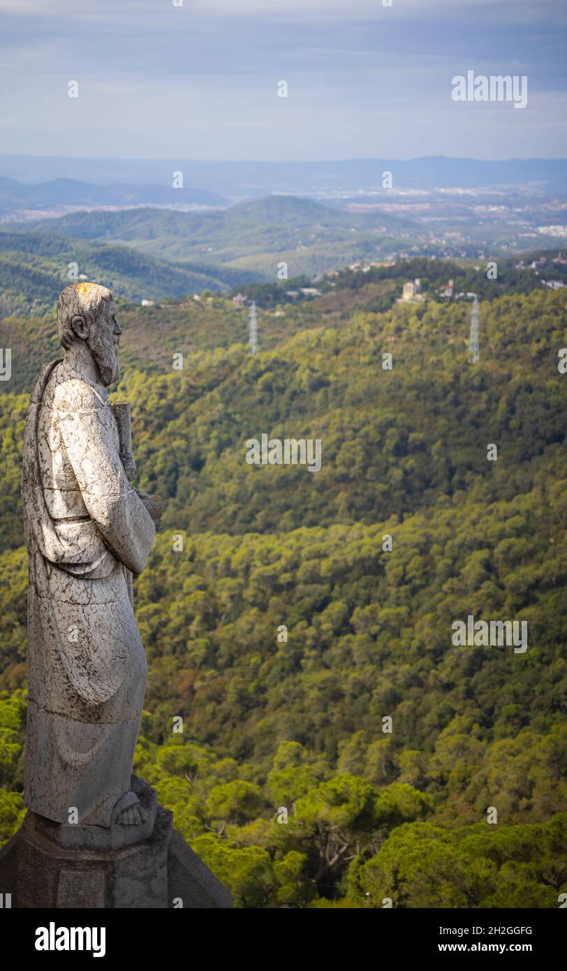 Stone statue on the roof of the Church of the Sacred Heart of Jesus on the summit of Parc Tibidabo in Barcelona, Spain. Cathedral sculptures, aerial Stock Photo