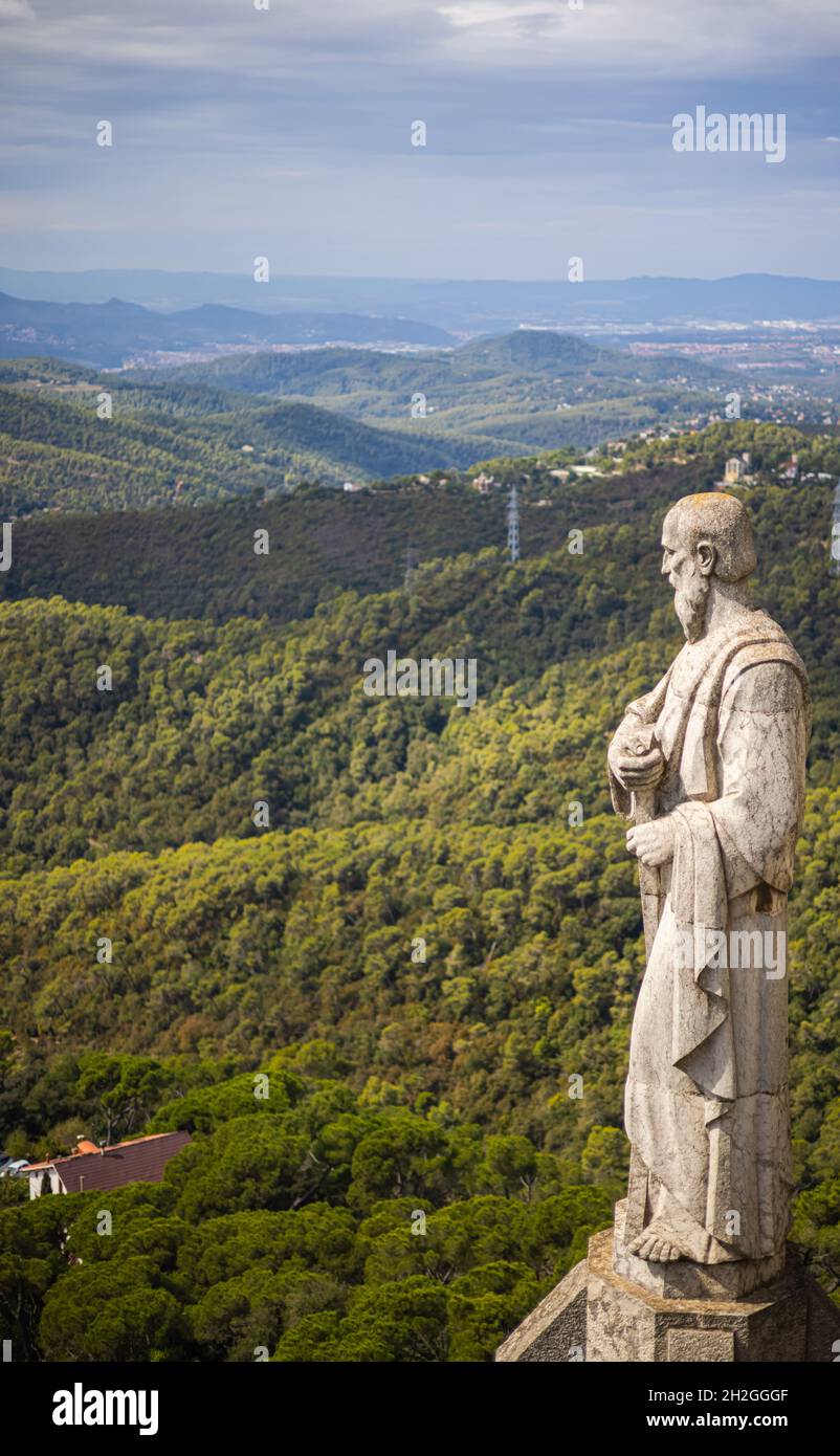 Stone statue on the roof of the Church of the Sacred Heart of Jesus on the summit of Parc Tibidabo in Barcelona, Spain. Cathedral sculptures, aerial Stock Photo