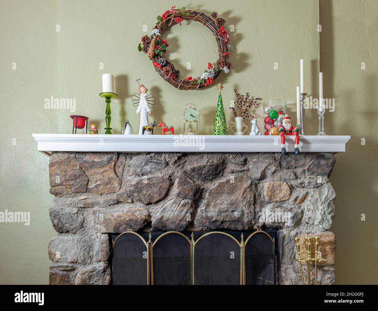 Rustic fieldstone fireplace decorated for Christmas with candles