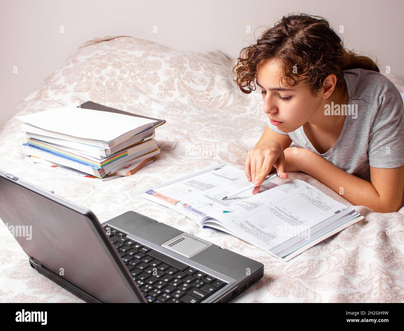 Teenager girl studying online at home. School girl with the lap top on