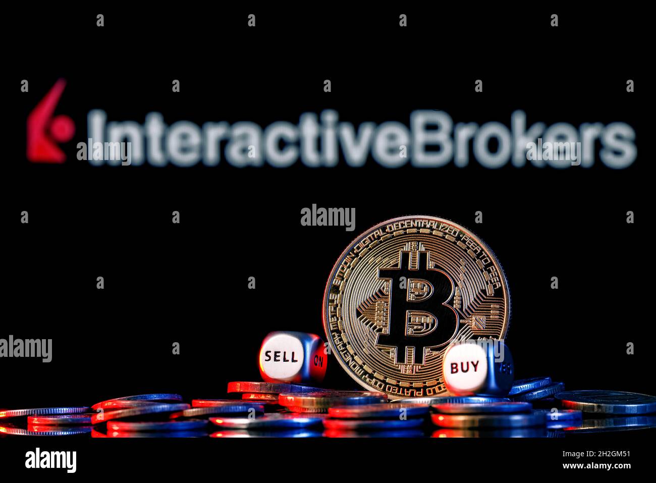 Golden bitcoin with two buy-sell cubes in a pile of coins on the background  of the Interactive Broker logo Stock Photo - Alamy