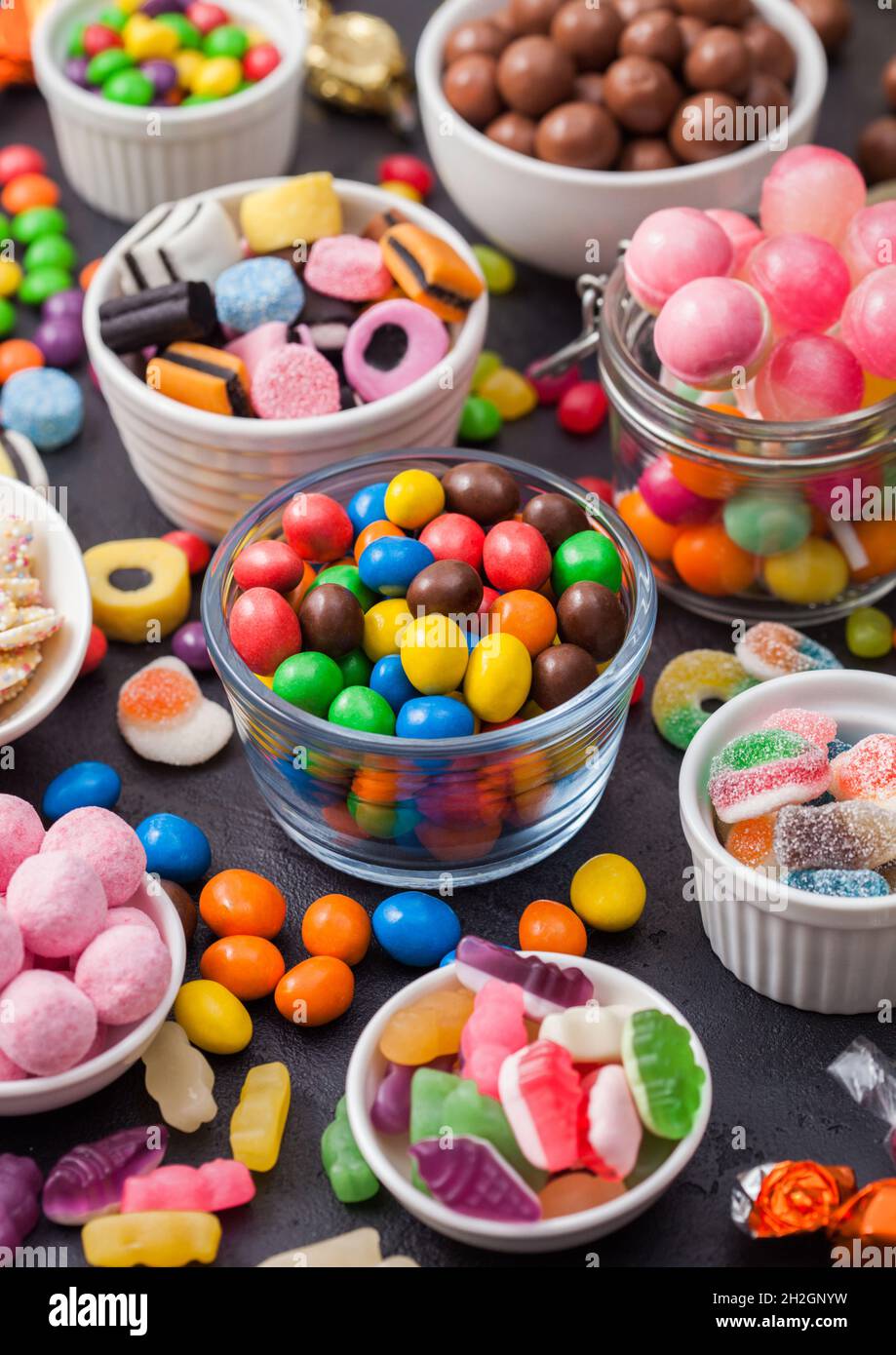 Variety of milk chocolate and jelly sugar gum sweets and candies on black.  Best snacks for kids parties Stock Photo - Alamy, image size:919x1390