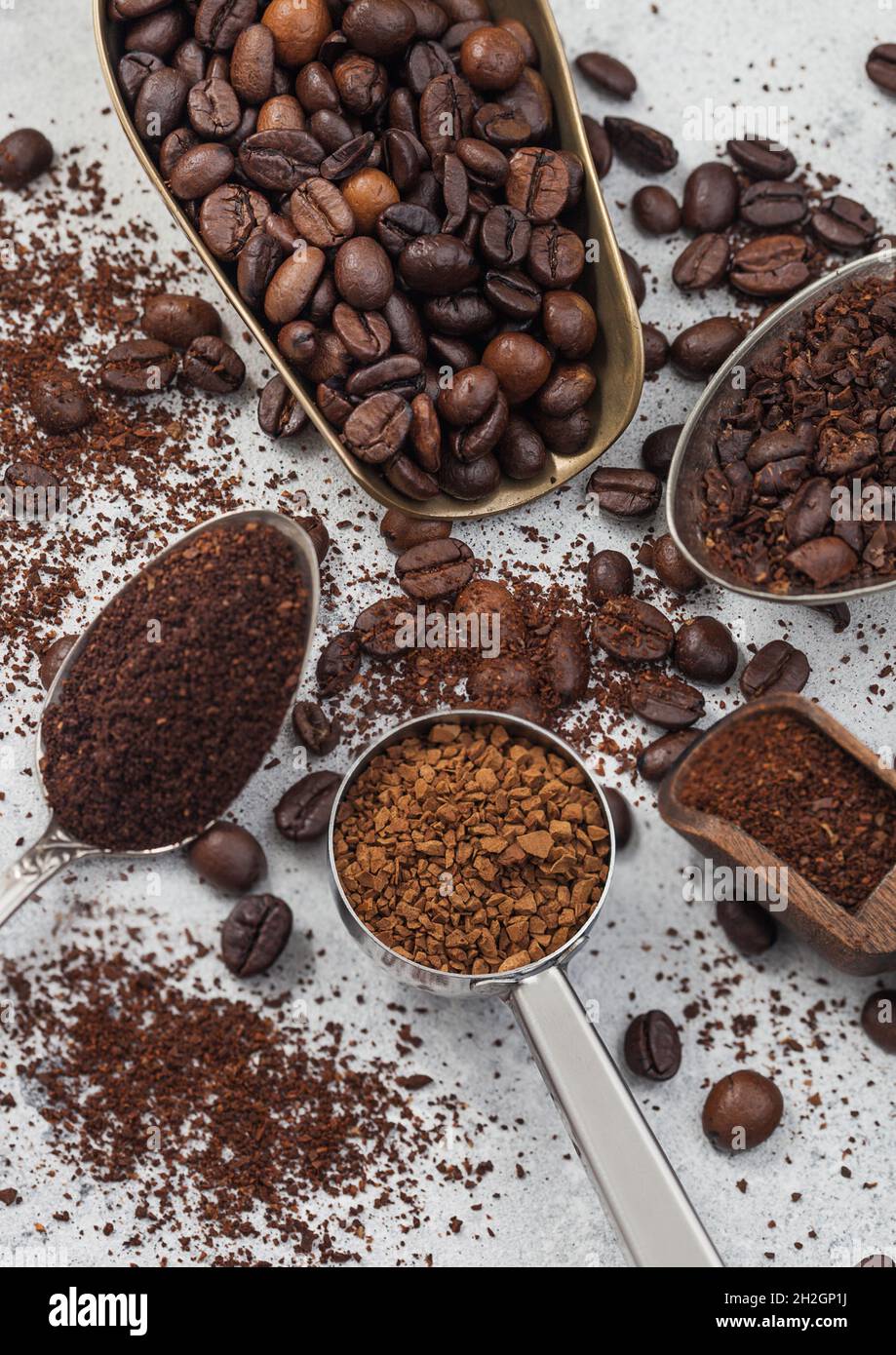 Various scoops with ground and bean coffee and freeze dried instant