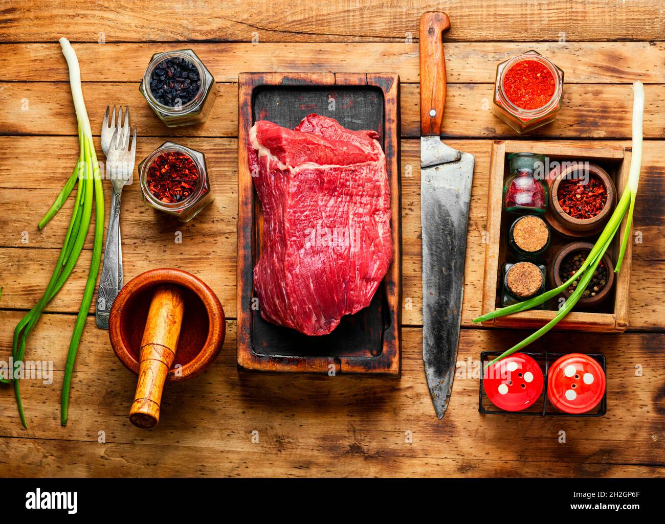 https://c8.alamy.com/comp/2H2GP6F/fresh-raw-beef-meat-on-wooden-cutting-board-2H2GP6F.jpg