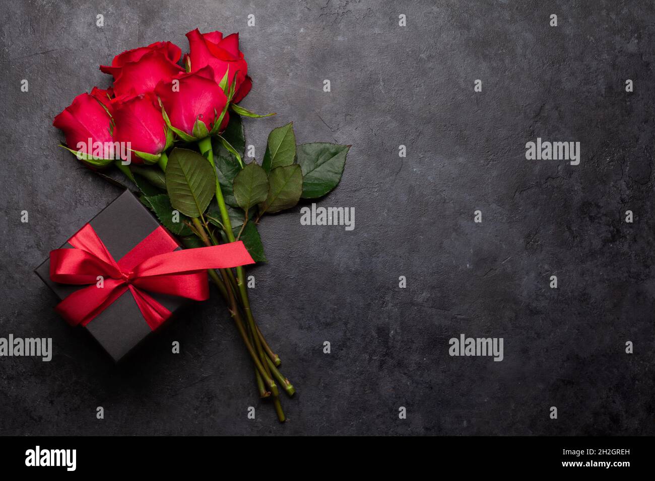 Valentines day greeting card with red rose flowers bouquet and gift box ...