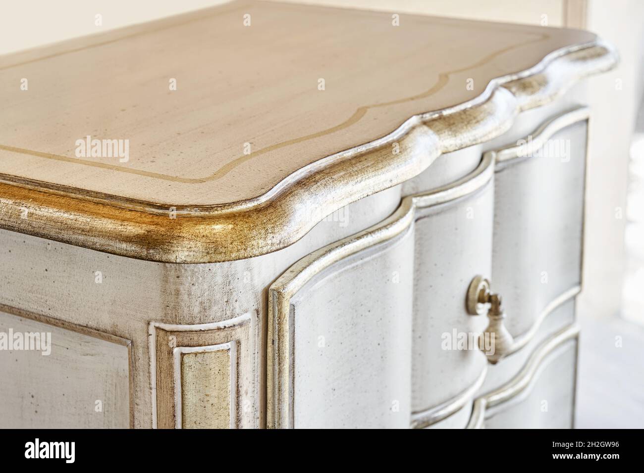 Elegant wooden nightstand made in classical style with open drawer with