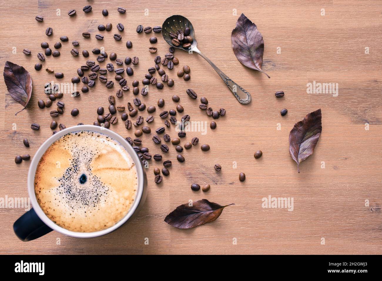 Coffee cup top view on wooden table background with coffee beans and ...
