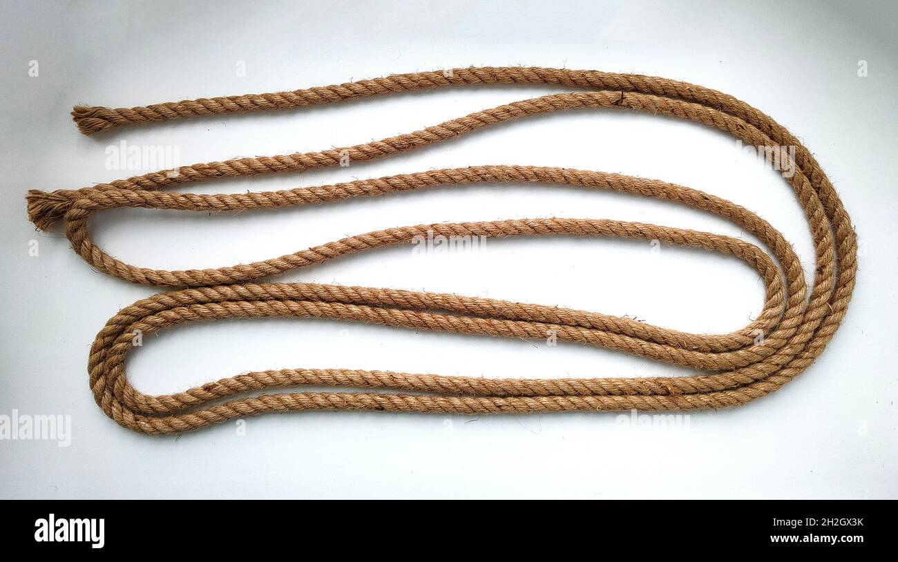Rough natural rope string on white background Stock Photo - Alamy