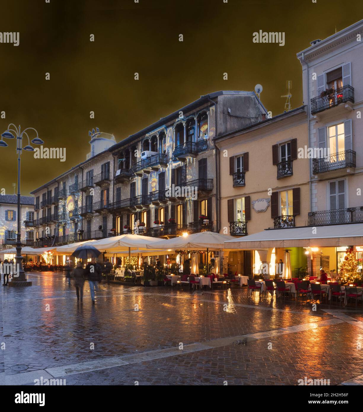 warm Christmas atmosphere in the historic center of Como illuminated in ...