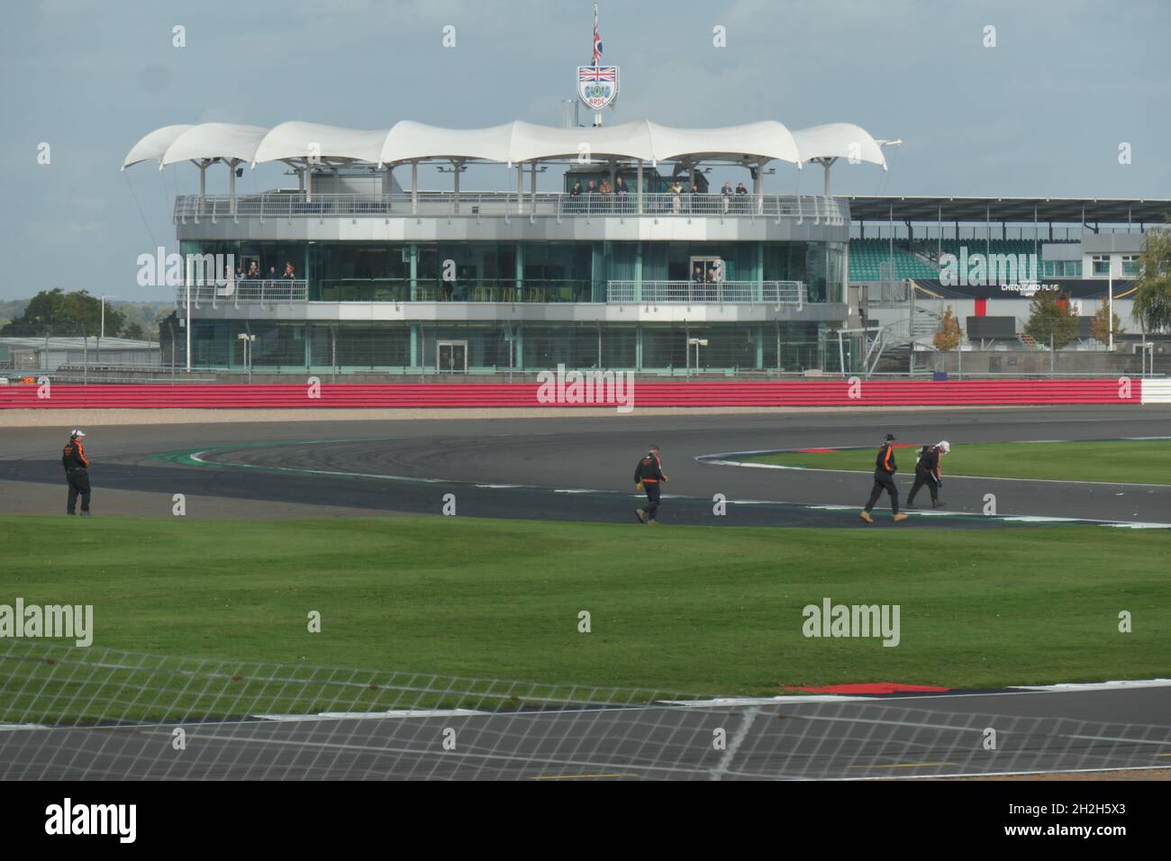 Silverstone motor racing circuit Northamptonshire UK stand stands marshal marshals track barriers barrier speed speedy canopy grass bend bends F1 Stock Photo